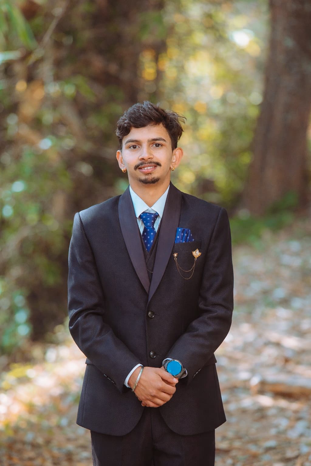 Aakash Neupane outdoors in a suit